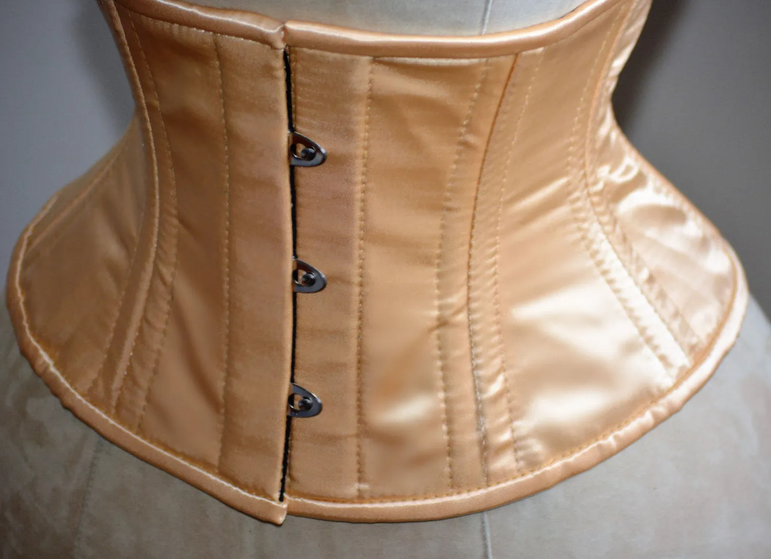 Short nude satin steelboned authentic waspie corset for tight lacing. Steel boned satin corset belt