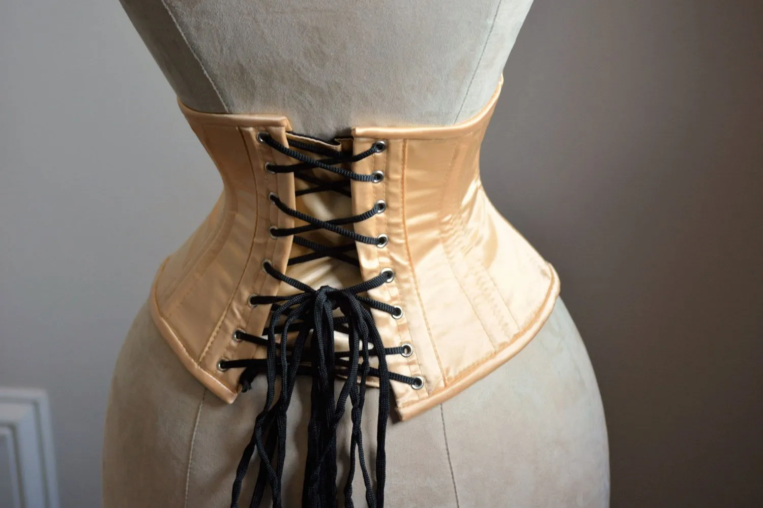 Short nude satin steelboned authentic waspie corset for tight lacing. Steel boned satin corset belt
